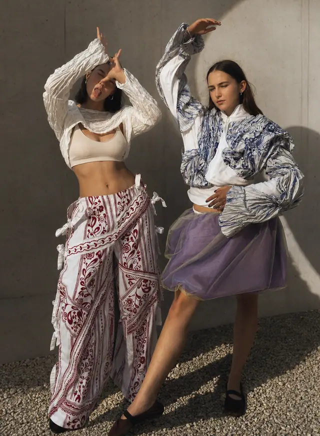 Zwei Models in Bewegung vor einer Betonwand